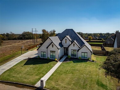 French country style house with a front lawn