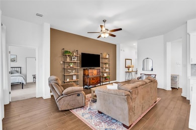 Living room featuring baseboards, visible vents, 
