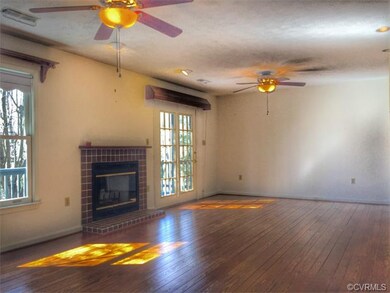 Family room w/hardwood floors and wood burning fir