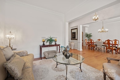 Elegant dining room with tray ceiling and wainscoting.