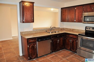 Kitchen with plenty of cabinets space. Looking int