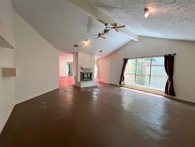 This spacious living room features a vaulted ceili