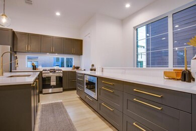 Kitchen featuring pendant lighting, sink, applianc