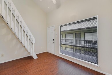 Entryway with high vaulted ceiling, light wood-st