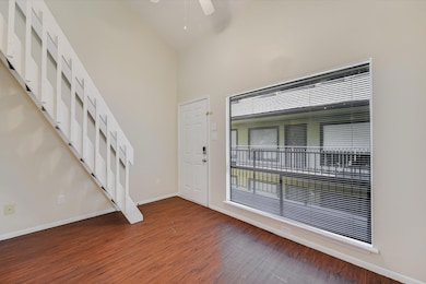 Entryway with high vaulted ceiling, light wood-st
