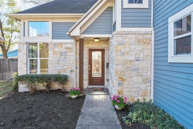 Doorway to property with stone siding, roof with 