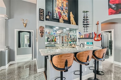 Bar featuring indoor wet bar, arched walkways, a h