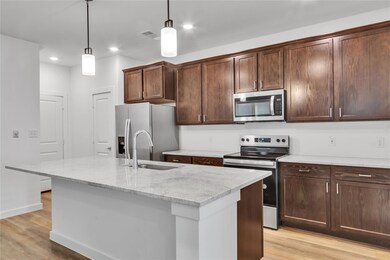 Kitchen with light wood-type flooring, a kitchen i