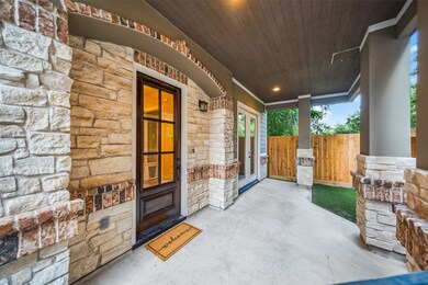 This inviting covered entry features rustic stonew