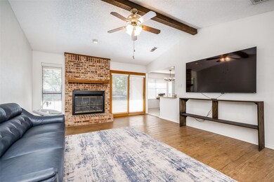 Living room with a fireplace, wood-type flooring, 