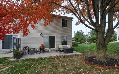 Back of house with a yard and a patio area
