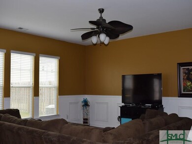 Great room with chair railing and picture molding.