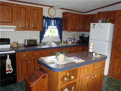 View of the Kitchen that comes complete with Stove and Refrigerator.