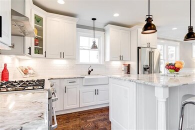 Recessed lighting and pendant lighting accents adds even more appeal to this large kitchen.