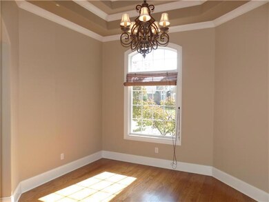The Formal Dining Room features beautiful hardwood floors, trey ceilings, custom molding, and a lovely chandelier. 