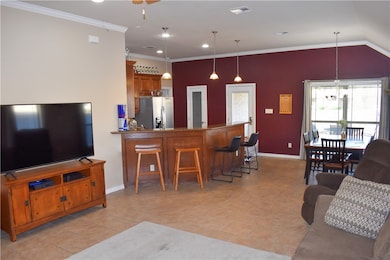 Living room opens up to kitchen and long eating ba