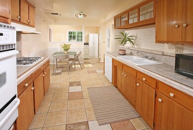 The chef in the family is going to truly appreciate the kitchens trey ceiling, abundant rich wood cabinetry, tiled counter-tops with back-splash, dual basin sink, newer gas cook-top, self-cleaning gas oven, dishwasher and easy care tiled floors. The 