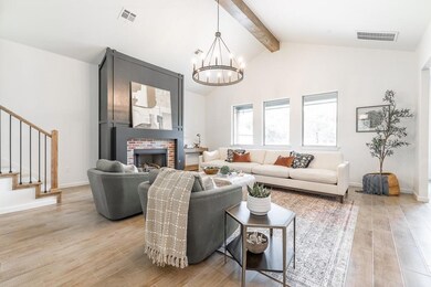 Living room with a chandelier, lofted ceiling with