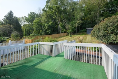 Fenced backyard featuring a storage shed