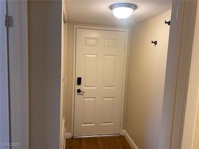 Entryway with wood finished floors and a textured ceiling