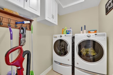 Laundry room with cabinet space and washing machine and dryer