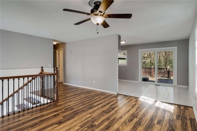 Spare room featuring baseboards, wood finished flo