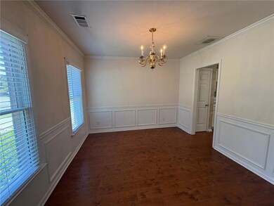 Unfurnished dining area with ornamental molding, a