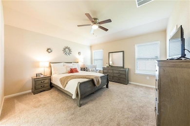 Bedroom featuring light colored carpet, multiple 
