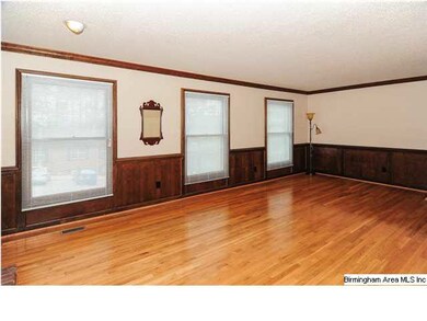 Living Room with hardwood floors and wood paneled 