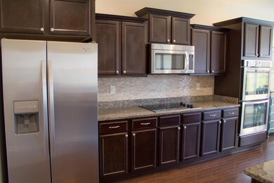 Upgraded luxury kitchen with granite surfaces & backsplash