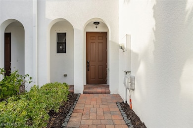 Entrance to property with stucco siding