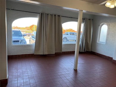 Tiled empty room with plenty of natural light and 
