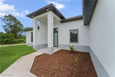 View of exterior entry with stucco siding and a la