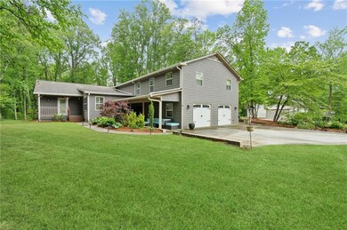 Rear view of house featuring a garage, covered por