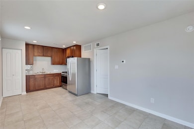 Kitchen featuring fridge with ice dispenser, stai