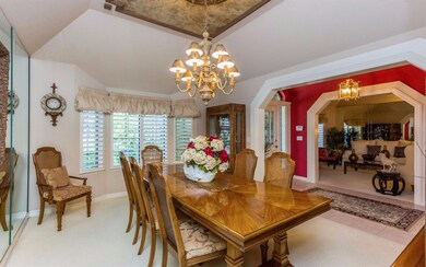 Large formal dining room with a bay window and tra