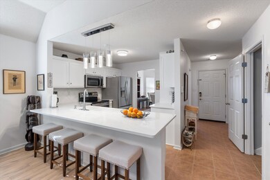 Kitchen featuring stainless steel appliances, whit