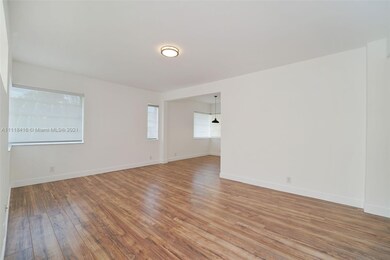 living room view from entryway showing dining area