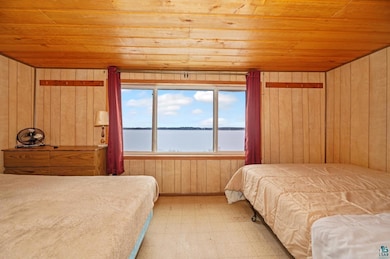 Bedroom with light tile patterned flooring, wooden