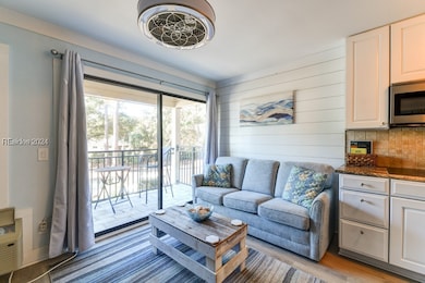 Living room with pull out sofa, light hardwood / w