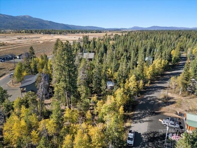 Aerial view of property and surrounding area featuring a mountainous background