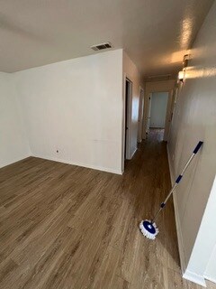 Empty room featuring dark wood-type flooring