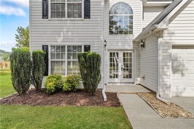 Entrance to property with french doors and a yard