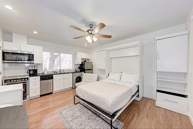 Bedroom with washer / clothes dryer, light wood f