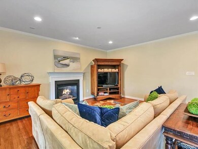 Family room with gas fireplace and hardwood floors