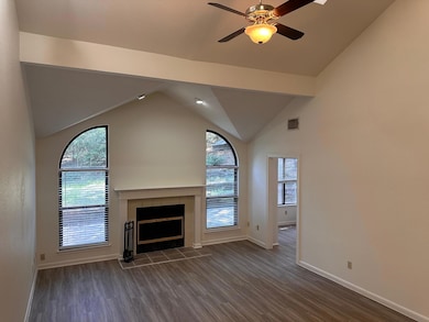 Unfurnished living room featuring baseboards, a t
