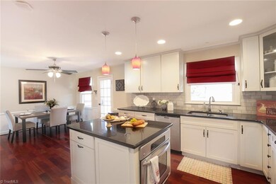 Gorgeous kitchen with  decorative pendant lighting over island and recessed lights