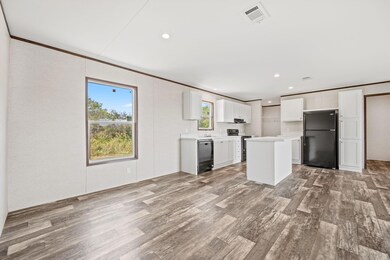 Kitchen featuring white cabinets, hardwood / wood-