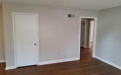 Unfurnished room featuring dark wood-type flooring
