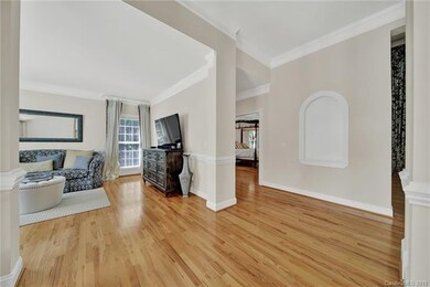 Short hallway behind living room leads to half-bat